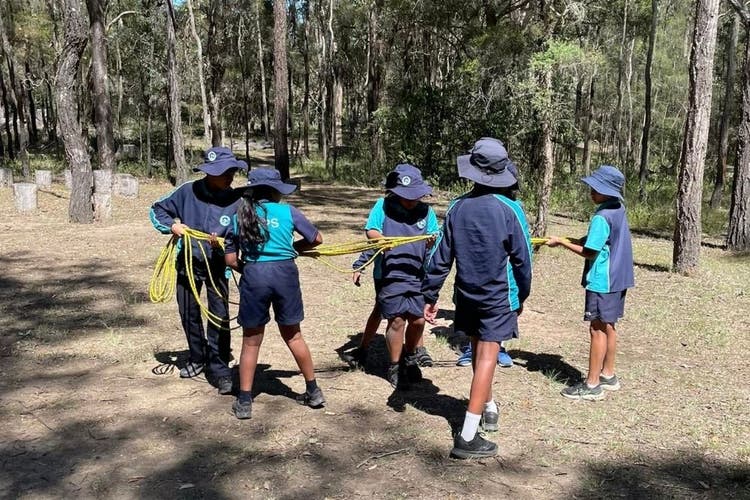 Students using a rope while completing a team challenge