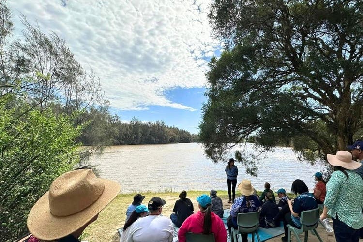 School staff looking out over Longneck Lagoon