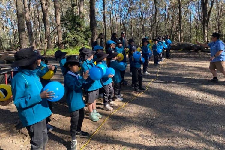 Students preparing to throw balls that represent rain droplets